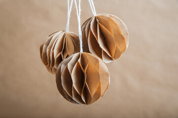 Selective focus. DIY Scandinavian Nordic Craft Paper Christmas Balls. Eco friendly New Year from...