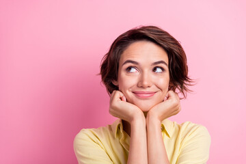 Photo of young attractive woman happy positive smile hands touch cheeks dream look empty space isolated over pink color background