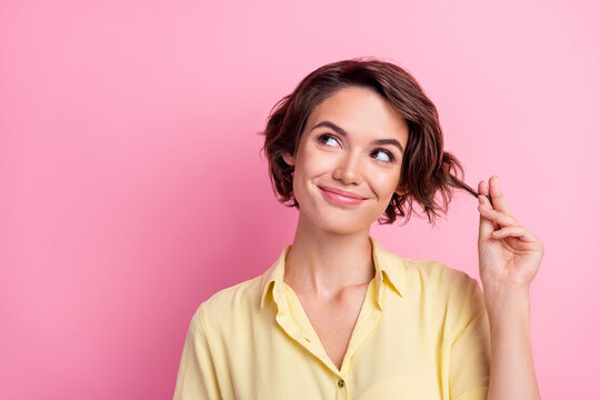 Photo of nice young brunette lady look empty space wear yellow t-shirt isolated on pink color background