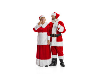 Portrait of two people, man in Santa Claus costume and crying woman, missis Claus isolated on white background.