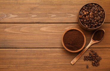 Coffee grounds and roasted beans on wooden table, flat lay. Space for text