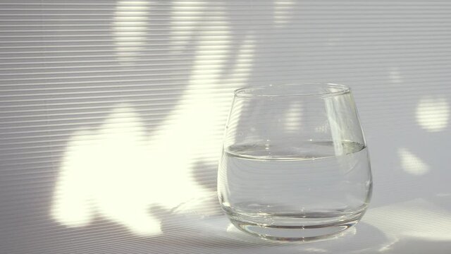 Take pills 4k video. Immunity busters Food supplements capsules. Vitamins and minerals. Pick up glass of water. 