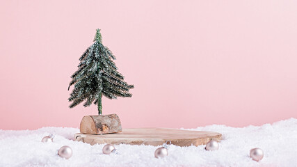 Christmas holiday wooden podium or stand in snow with mini Christmas tree