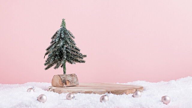 Christmas holiday wooden podium or stand in snow with mini Christmas tree