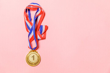 Simply flat lay design winner or champion gold trophy medal isolated on pink colorful background....