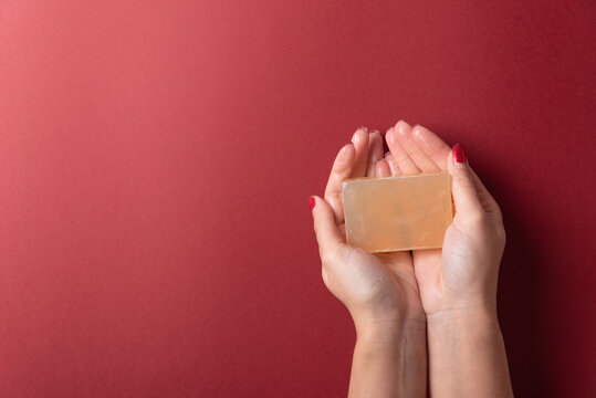 Woman hands holding soap on plain copy space