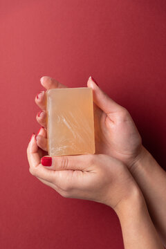 Feminine hands showing soap on copy space