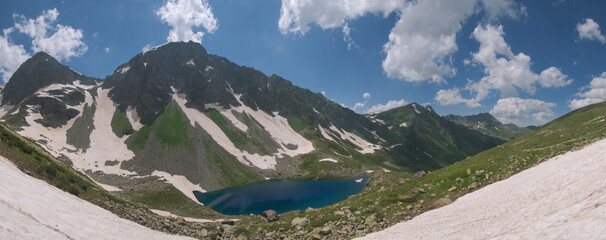 A large, blue mountain lake in summer in high resolution.
