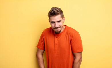 young handsome man looking proud, confident, cool, cheeky and arrogant, smiling, feeling...