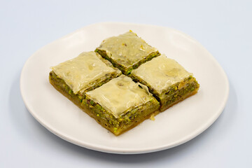 Pistachio baklava on a white background. Turkish style pistachio baklava presentation and service. Horizontal view. close up