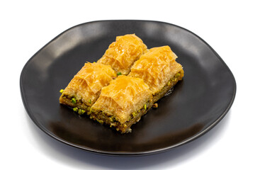 Pistachio baklava isolated on a white background. Turkish style pistachio baklava presentation and service. Horizontal view. close up
