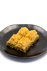 Pistachio baklava isolated on a white background. Turkish style pistachio baklava presentation and service. Vertical view. close up