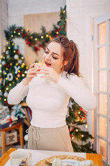 woman in  christmas decorated room witha cake