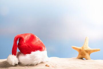 Santa claus hat on sand beach.Christmas.
