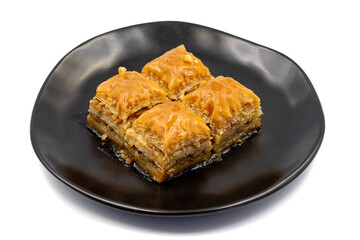 Walnuts baklava isolated on a white background. Turkish style walnut baklava presentation and service. Horizontal view. close up