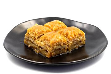 Walnuts baklava isolated on a white background. Turkish style walnut baklava presentation and service. Horizontal view. close up