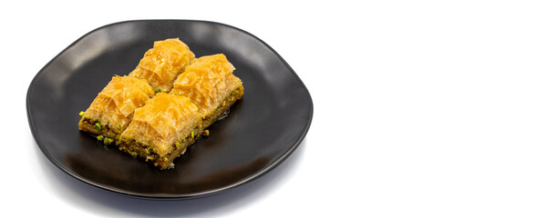 Pistachio baklava isolated on a white background. Turkish style pistachio baklava presentation and service. Empty space for text. Copy space