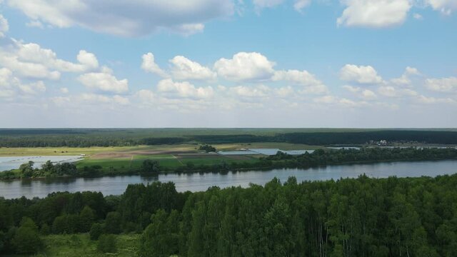 Russia, Pushchino. Aerial video of a drone flying over the Oka River at sunny day. A river in the European part of Russia, the largest right tributary of the Volga River.