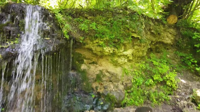 Russia, Pushchino on the Oka River. A beautiful waterfall near Moscow in the summer. Aerial Video of Eco trail and green vegetation.