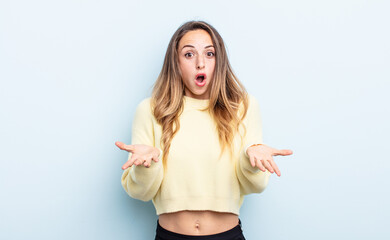 pretty caucasian woman feeling extremely shocked and surprised, anxious and panicking, with a...