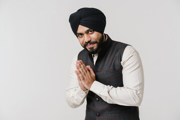 Bearded south asian man wearing turban smiling and gesturing