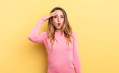 pretty caucasian woman looking happy, astonished and surprised, smiling and realizing amazing and...
