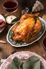 baked chicken in Christmas dekor with candles and serving