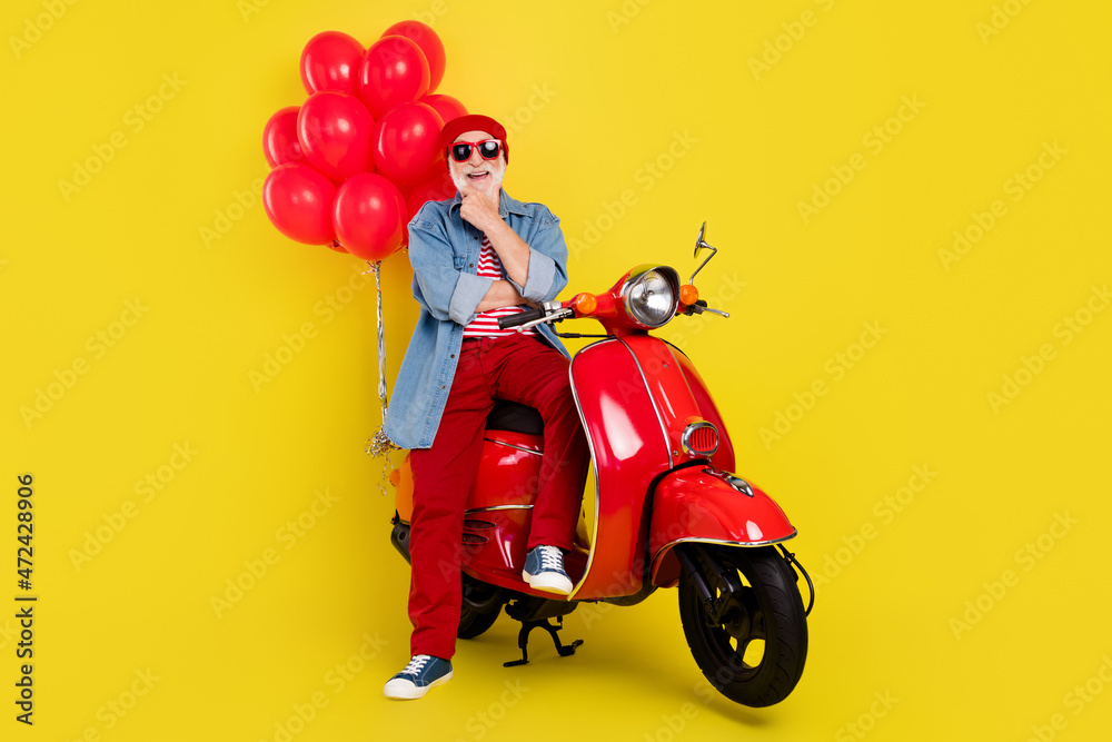 Sticker Portrait of bearded elderly retired pensioner trendy man sitting on moped black friday isolated over vivid yellow color background