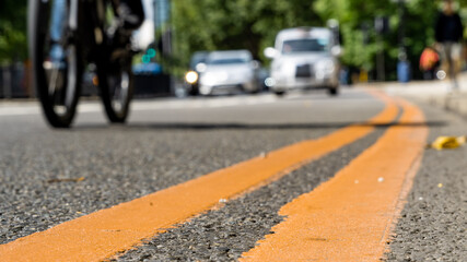 Double Yellow lines and a cyclist on a busy road in London	