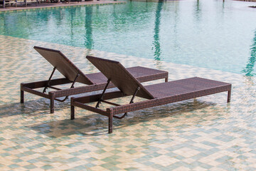 Deck chairs in the swimming pool at a tropical resort near sea in Burma, Myanmar