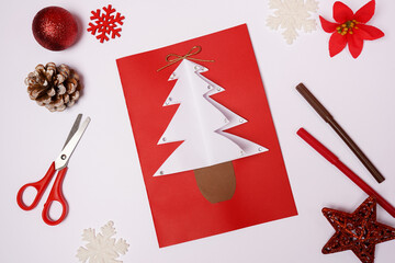 DIY Christmas card with fir-tree from colored paper on white background