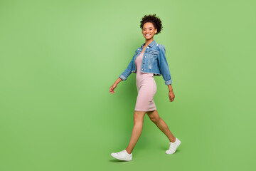 Fototapeta na wymiar Full size profile photo of cute millennial lady go wear dress shirt sneakers isolated on green background