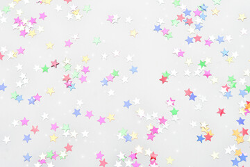 background with scattered multicolored glitter stars. Abstract pattern. Place for text