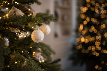 Decorative christmas white balls on a tree with bokeh in the background, shallow depth of field,...