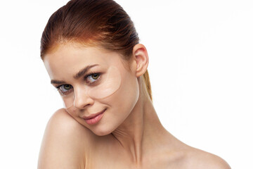 Fototapeta premium pretty woman in patches on face rejuvenation spa treatments