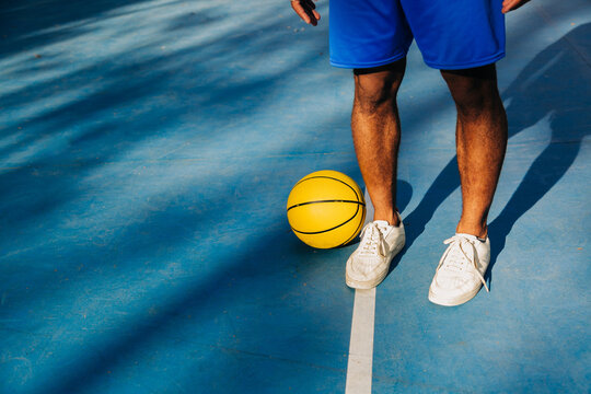 Anonymous Black Basketball Player Holding Ball