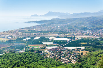 Obraz premium top view of Mediterranean coastal resort village with gardens and hotels in Camyuva, Turkey