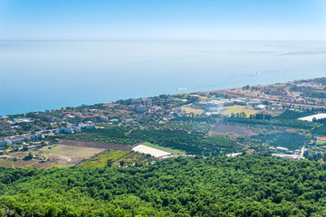 Fototapeta na wymiar top view of Mediterranean coastal resort village with gardens and hotels in Camyuva, Turkey