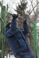 A guy performing a sporting activity on a street playground