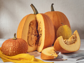 Orange pumpkins of various sizes on a light table