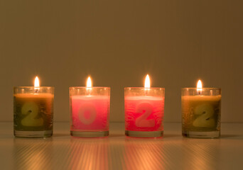 Burn a beautiful candle with numbers 2022 for the new year.