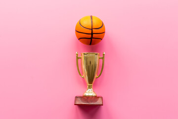 Sport champion award - golden trophy cup with game ball, top view