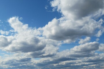 Blue sky background with white cumulus clouds
