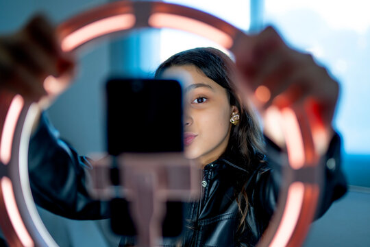 Underage girl using a ring of light to broadcast online on social networks
