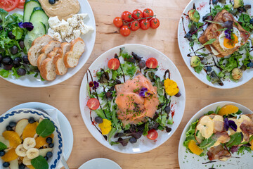 Danish open sandwich Smorrebrod with salmon on rye bread with vegetables and herbs
