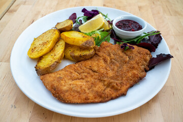 Tender schnitzel with fresh salad, tomatoes and french fries