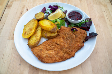 Tender schnitzel with fresh salad, tomatoes and french fries