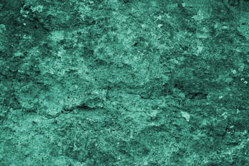 Emeral green colored concrete stone uneven surface closeup texture background concept design