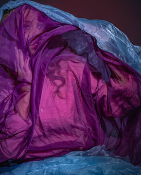 A Girl Covered With A Purple Transparent Cloth