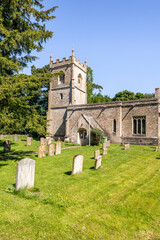 Naklejka premium The 12th century Norman church of St Andrew in the Cotswold village of Cold Aston (aka Aston Blank), Gloucestershire UK